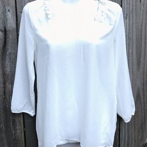 Cream top with ruffle neckline by Peach Love